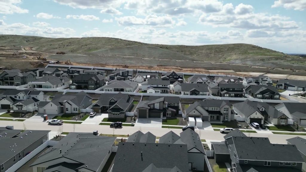 Aerial view of Dry Creek Ranch homes with the Boise foothills behind the community