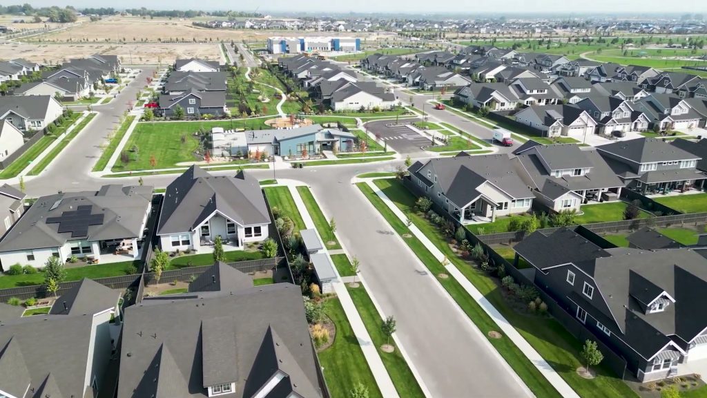 Aerial view of part of Pinnacle in South Meridian with homes, paths, green space and community buildings